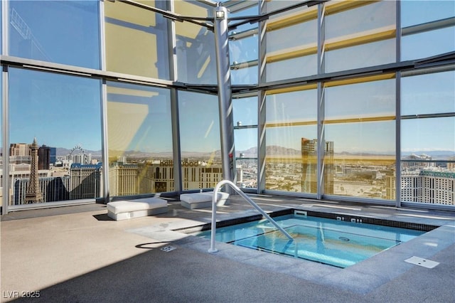 view of swimming pool with an indoor hot tub