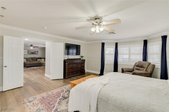 bedroom with light wood-type flooring, ceiling fan, and ornamental molding