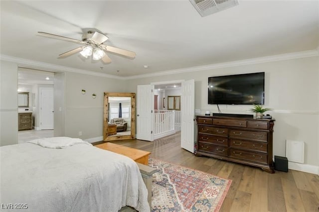 bedroom with light hardwood / wood-style floors, ceiling fan, and ornamental molding