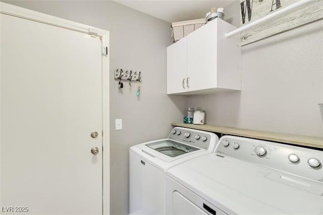 washroom with separate washer and dryer and cabinets