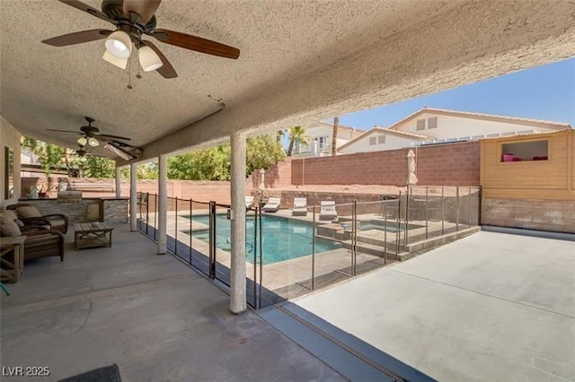 view of swimming pool with a patio and ceiling fan