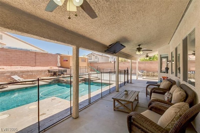 view of swimming pool featuring ceiling fan, a patio area, and outdoor lounge area