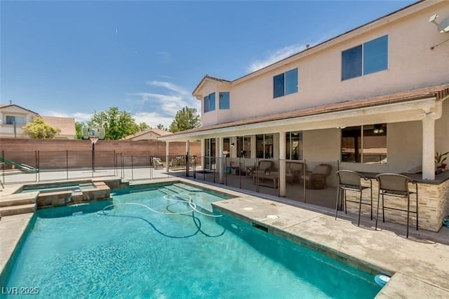 view of pool featuring a patio, an in ground hot tub, and a bar