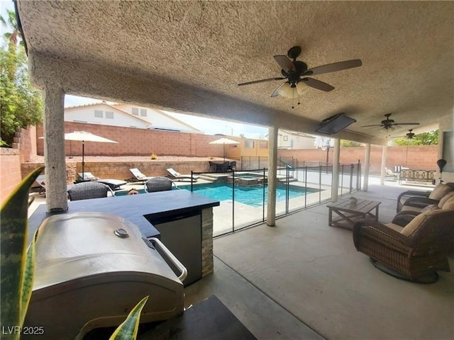 view of swimming pool with ceiling fan and a patio area