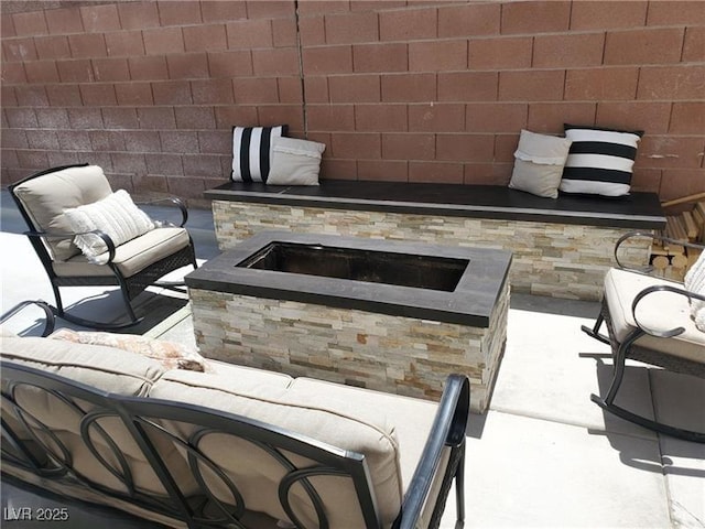 view of patio featuring an outdoor living space with a fire pit