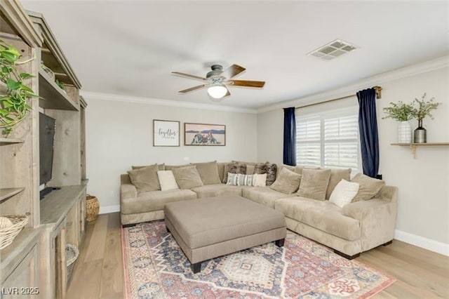 living room with light hardwood / wood-style floors, crown molding, and ceiling fan