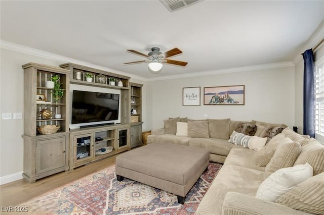 living room with ceiling fan, crown molding, and light hardwood / wood-style floors