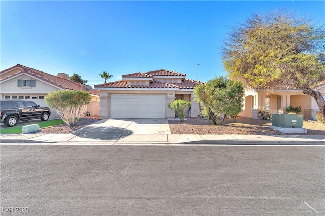 mediterranean / spanish-style house with stucco siding, a tiled roof, driveway, and a garage