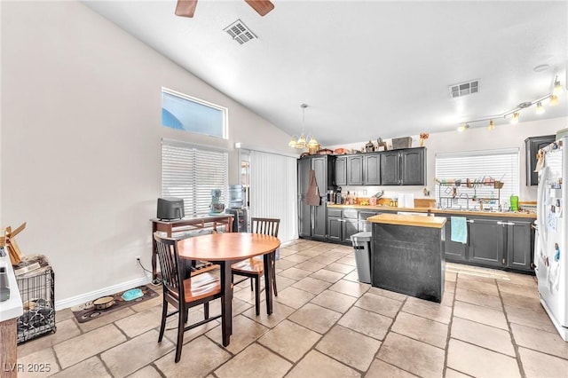 kitchen featuring a wealth of natural light, visible vents, and lofted ceiling