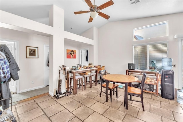 dining room featuring baseboards, lofted ceiling, and ceiling fan