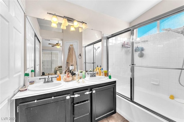 bathroom featuring a sink, combined bath / shower with glass door, ensuite bathroom, and double vanity