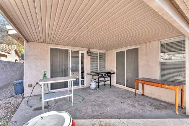 view of patio featuring fence