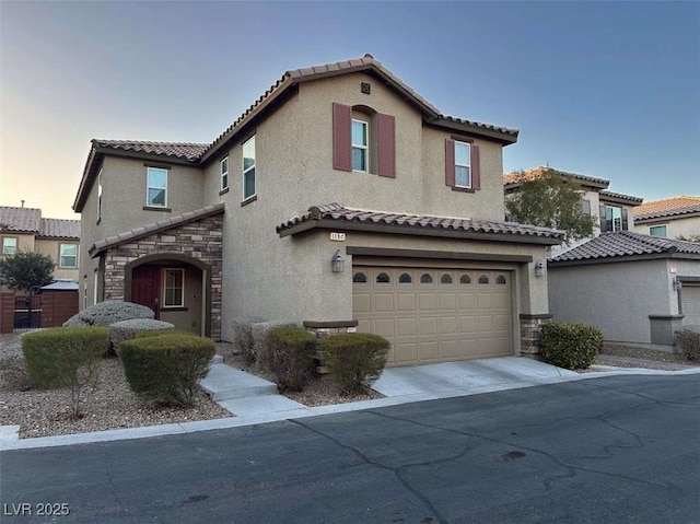 mediterranean / spanish-style house with a garage