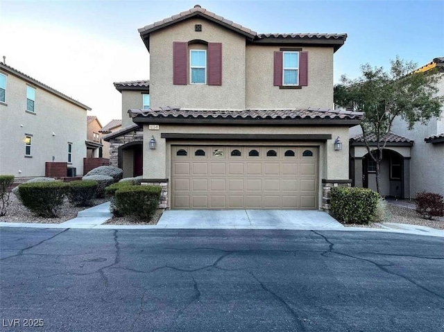 view of front facade featuring a garage, driveway, and stucco siding