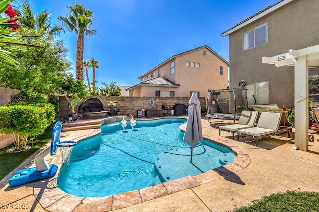 view of swimming pool featuring a trampoline, a patio area, and pool water feature