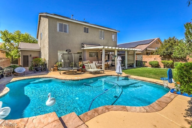 view of pool featuring a patio, a yard, a pergola, and a trampoline