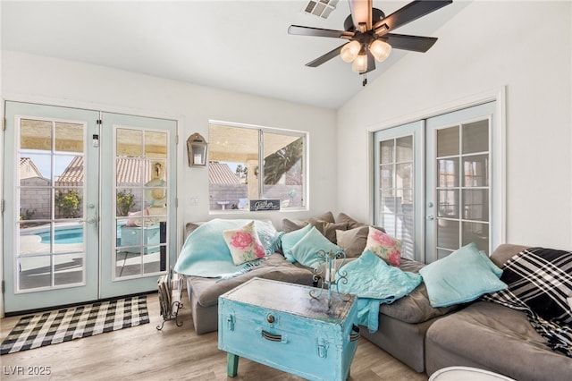 interior space with ceiling fan, light wood-type flooring, french doors, and lofted ceiling