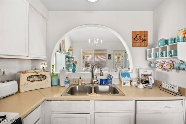 kitchen featuring sink, dishwasher, a chandelier, and white cabinets