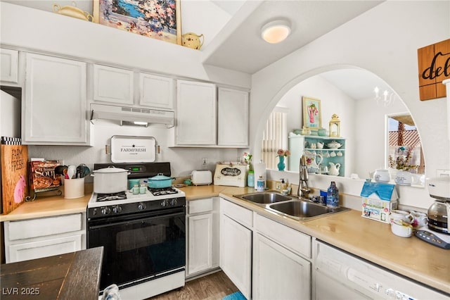 kitchen with sink, white appliances, hardwood / wood-style flooring, and white cabinetry