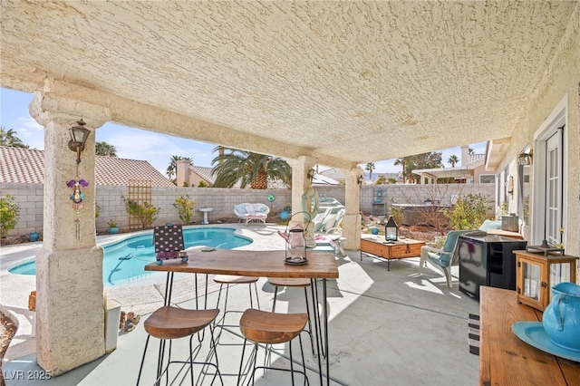 view of patio featuring a fenced in pool