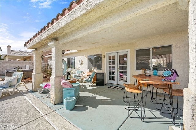 view of patio featuring french doors and a hot tub