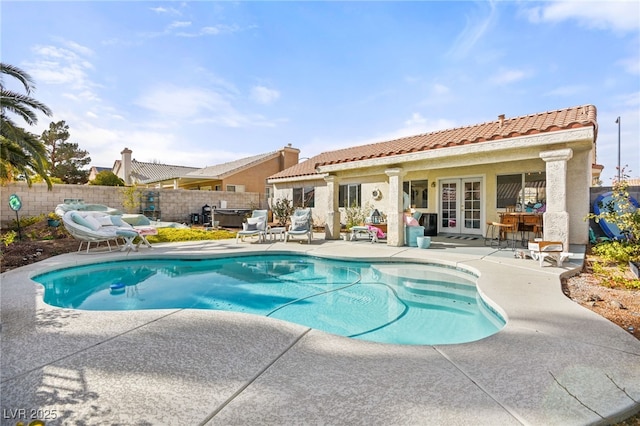 view of swimming pool featuring a patio area and french doors