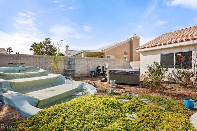 view of yard with a hot tub