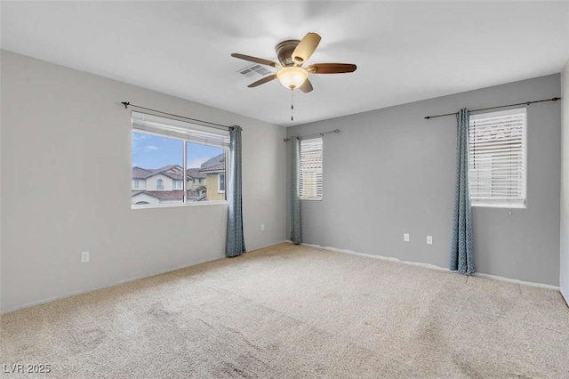 empty room featuring carpet flooring and ceiling fan