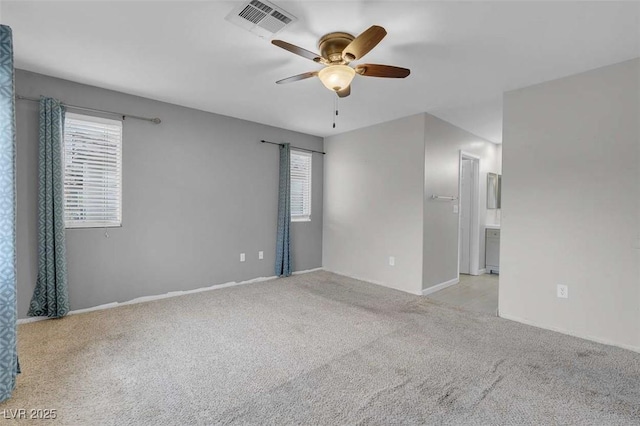 unfurnished room with light colored carpet and ceiling fan