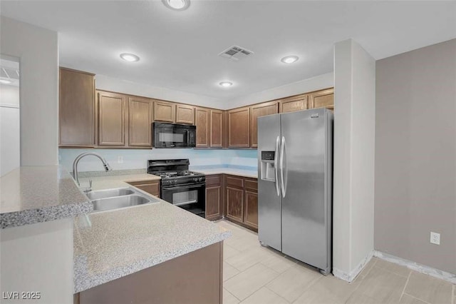 kitchen featuring sink, kitchen peninsula, and black appliances