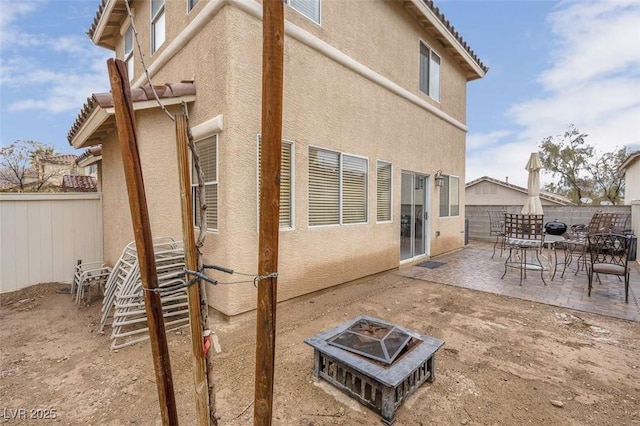 back of house featuring a patio area and an outdoor fire pit