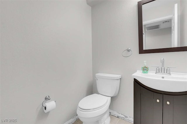 bathroom featuring toilet and vanity