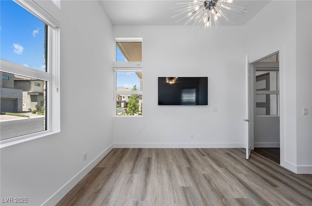 interior space with light wood-type flooring and a notable chandelier