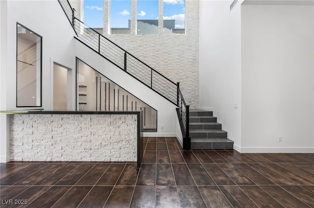 interior space featuring tile patterned flooring and a towering ceiling