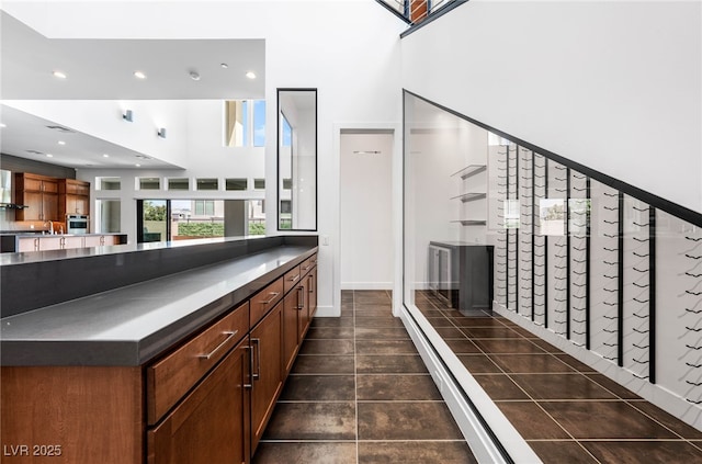 interior space with a high ceiling, sink, and oven