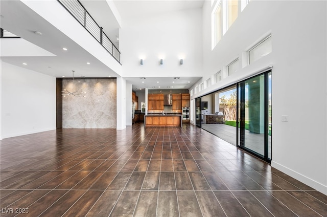 unfurnished living room featuring dark tile patterned flooring