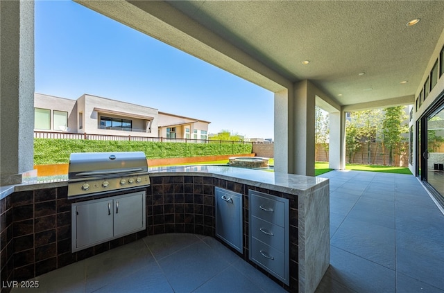 view of patio / terrace featuring grilling area and an outdoor kitchen