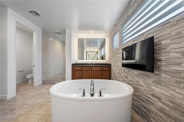 full bathroom with separate shower and tub, vanity, tile patterned flooring, and toilet