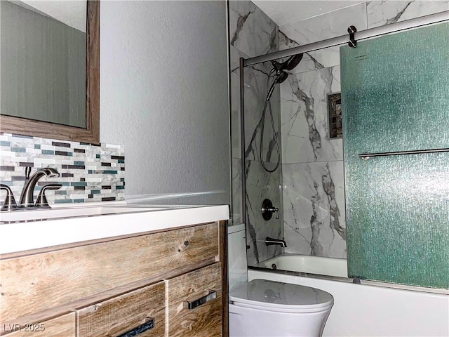 full bathroom with decorative backsplash, vanity, toilet, and enclosed tub / shower combo