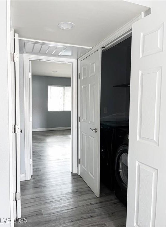 hall featuring hardwood / wood-style floors and washer / dryer