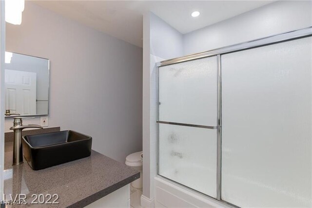 5816 W Cherokee Ave, Las Vegas, NV 89103 - full bathroom with combined bath / shower with glass door, vanity, and toilet