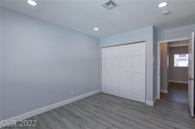 5816 W Cherokee Ave, Las Vegas, NV 89103 - unfurnished bedroom with white fridge, light wood-type flooring, and a closet