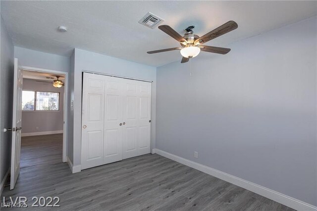 5816 W Cherokee Ave, Las Vegas, NV 89103 - unfurnished bedroom with a closet, ceiling fan, and dark hardwood / wood-style floors