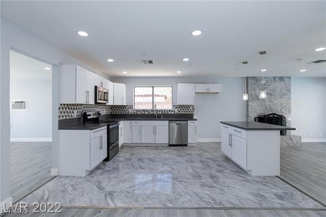 5816 W Cherokee Ave, Las Vegas, NV 89103 - kitchen featuring hanging light fixtures, stainless steel appliances, white cabinets, backsplash, and a fireplace