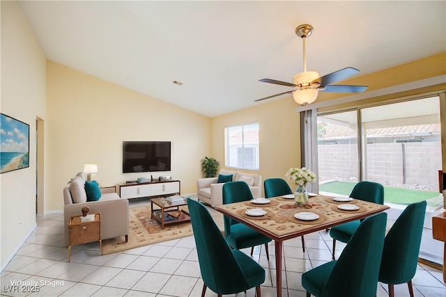 dining room with light tile patterned floors, visible vents, lofted ceiling, and a ceiling fan