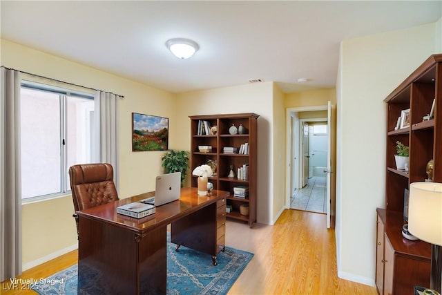 office featuring baseboards and light wood-style floors