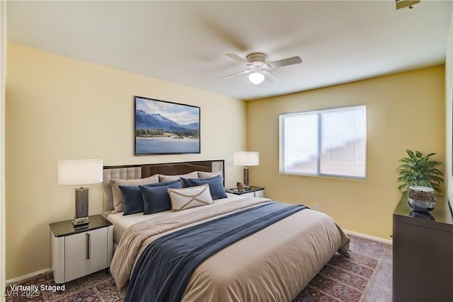 bedroom featuring a ceiling fan, baseboards, and dark carpet