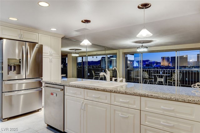 kitchen with stainless steel appliances, light stone counters, decorative light fixtures, light tile patterned floors, and sink