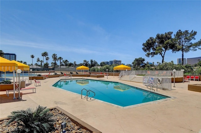 view of pool with a patio area and a water slide