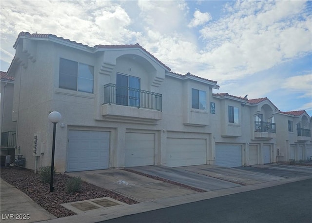 view of front of house featuring central AC and a balcony